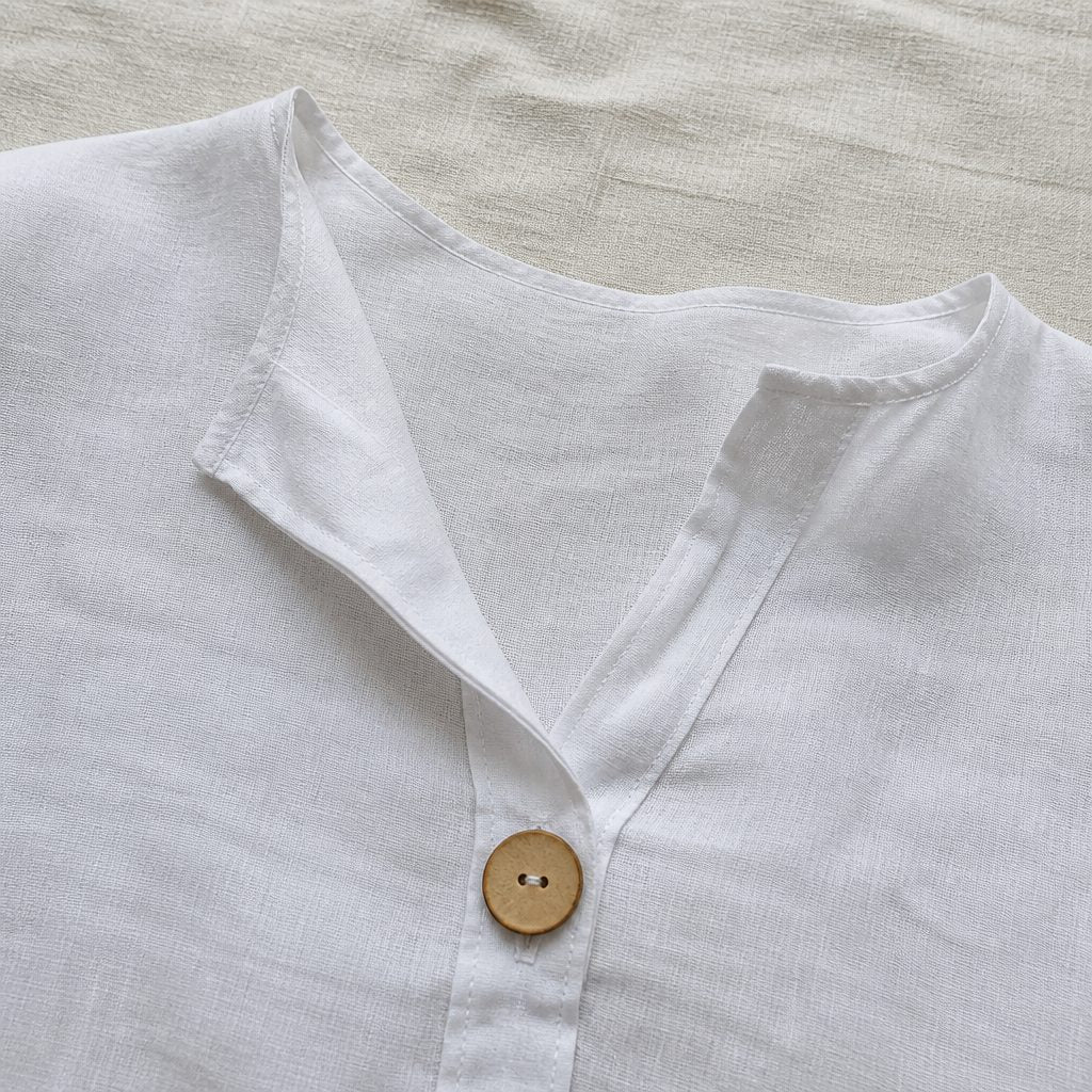 The open collar and wooden button detail